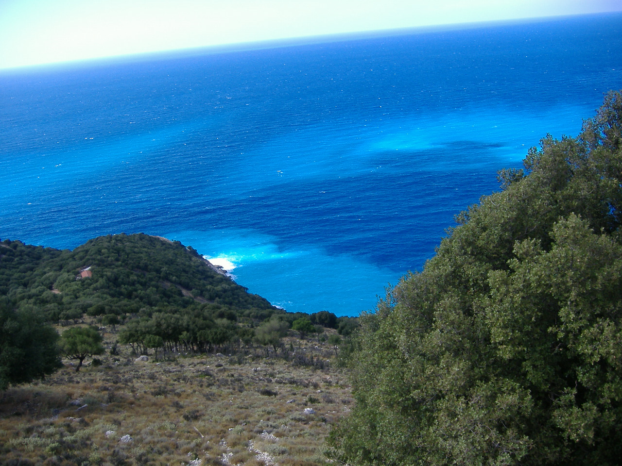 A view of a hidden beach from a hillside.
