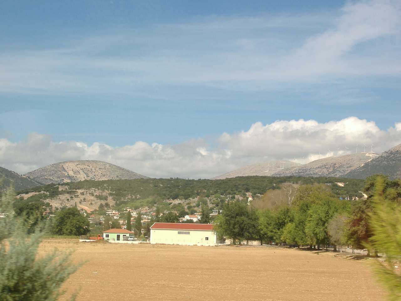 The countryside of Kefalonia with hills and houses.