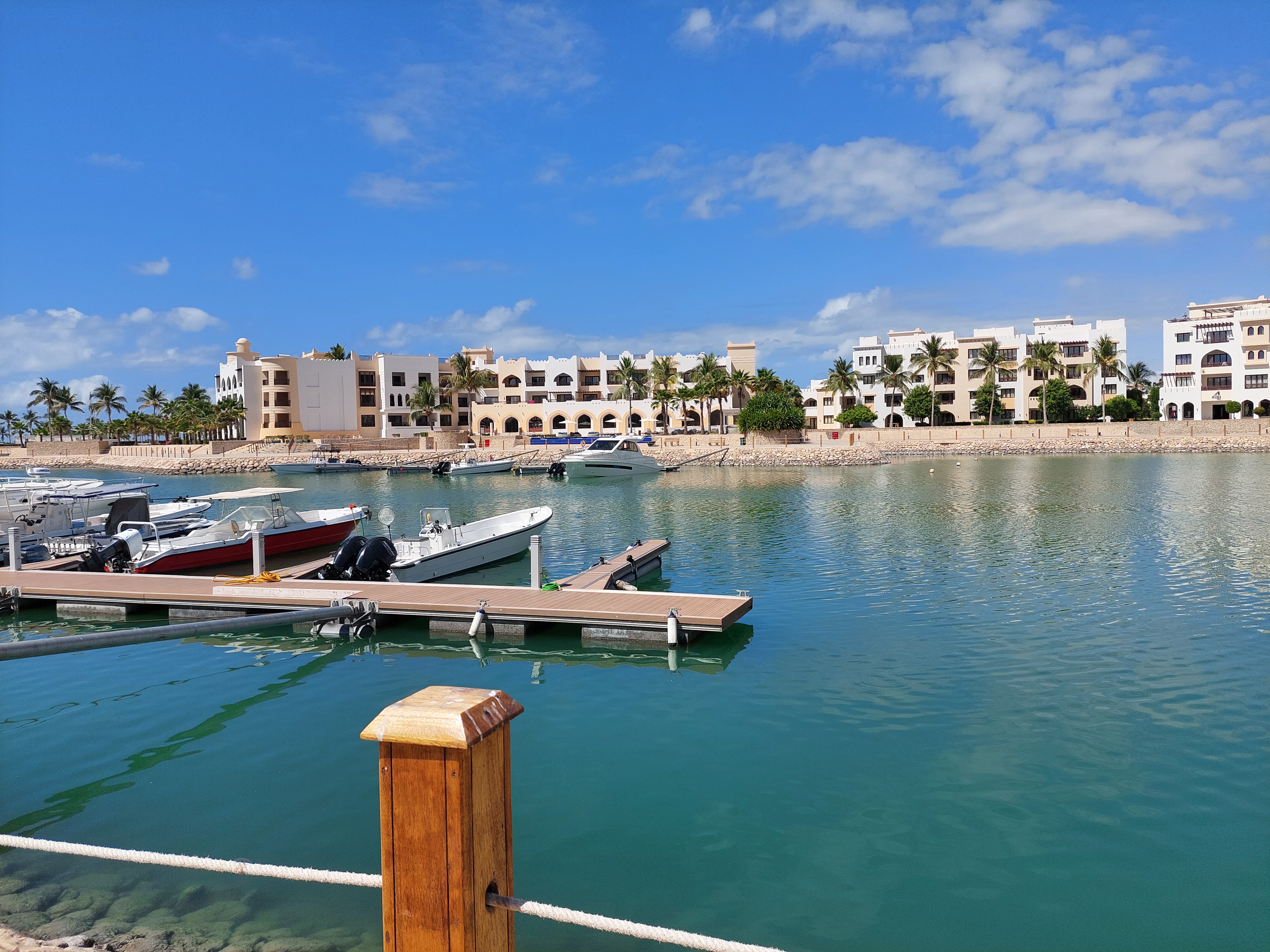 View of the Fanar Hotel's port with yachts and surrounding buildings in Salalah, Oman.
