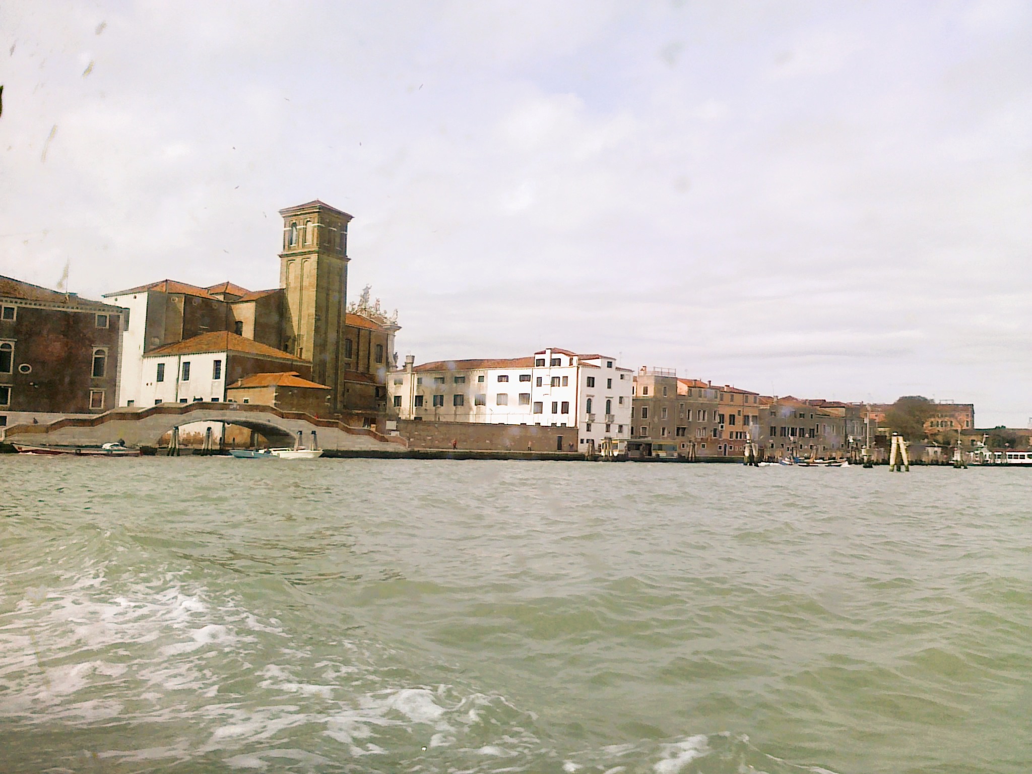Buildings and a bridge along the Grand Canal from the water.