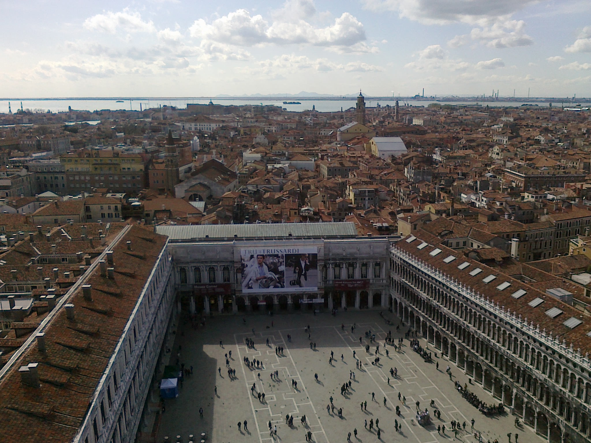 A panoramic shot from the Campanile overlooking St. Mark's Square with people below.