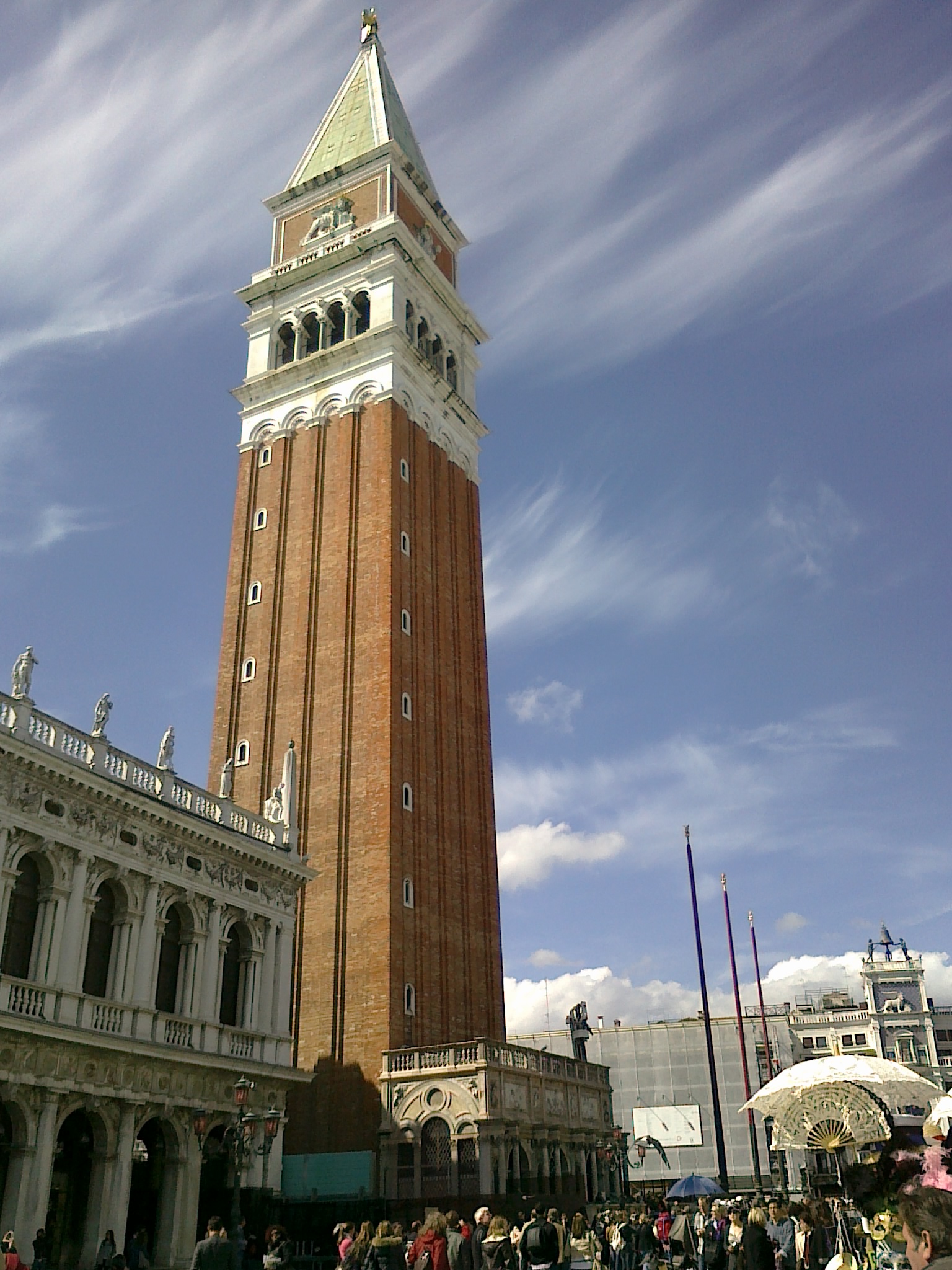 A low-angle shot of the Campanile bell tower in St. Mark's Square.